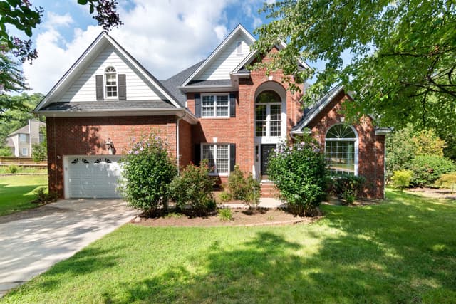 Two-story brick home with landscaped front yard in Middle Tennessee