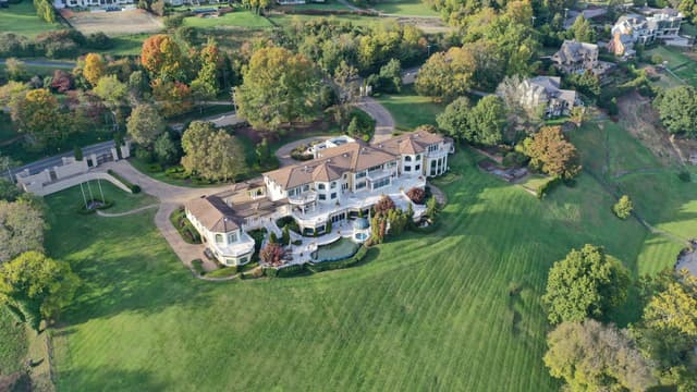 Aerial view of a large estate property with landscaped grounds